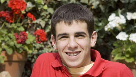 teenage boy with braces smiling