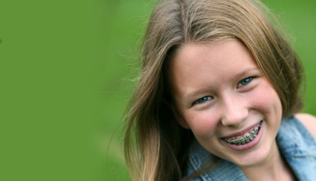 smiling girl with braces outside