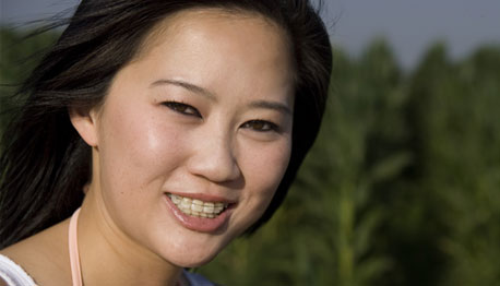 smiling teenage girl with braces outside