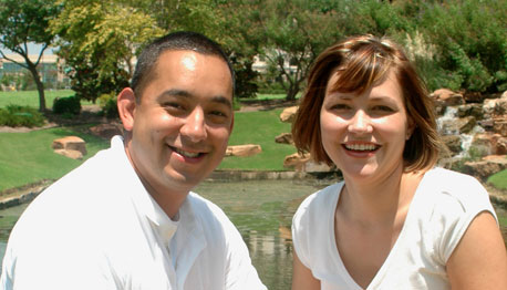 smiling adult couple outside in a park