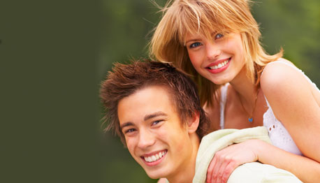 smiling teenage couple outdoors